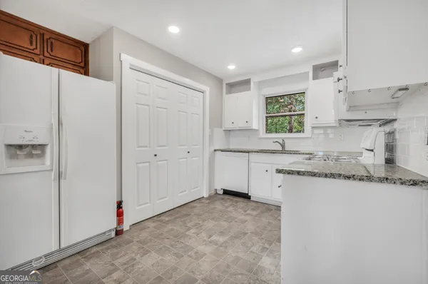 a kitchen with stainless steel appliances granite countertop a sink and cabinets