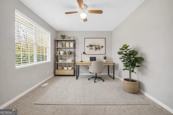 a spacious bedroom with a bed and a potted plant