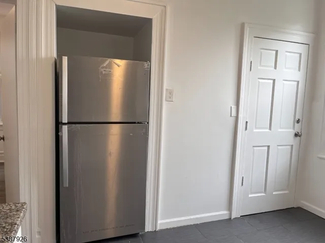 a view of a refrigerator in kitchen