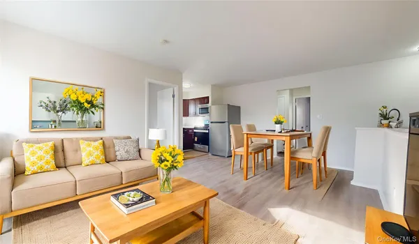 a living room with furniture and kitchen view