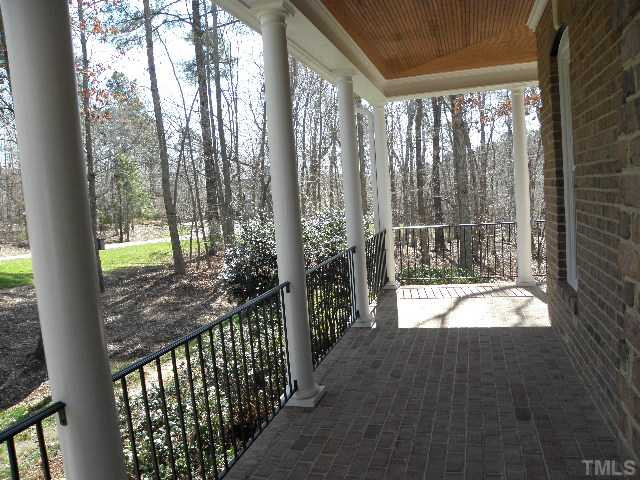7009 Millstone Ridge Court Raleigh, NC 27614 - Photo 2 of 25 Beaded ceiling and wrought iron railing make this nearly all brick home for sale in North Raleigh a rare find. This basement home for under 600 thousand is an executive masterpiece. Porch