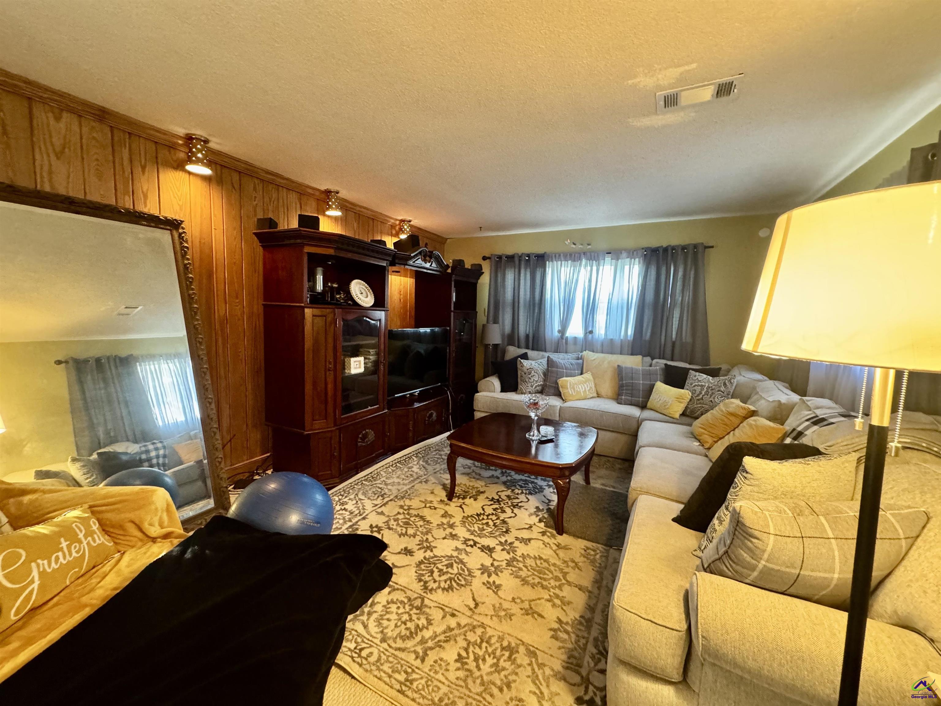 914 Adderton Street Americus, GA 31719 - Photo 12 of 53 a living room with furniture and a flat screen tv