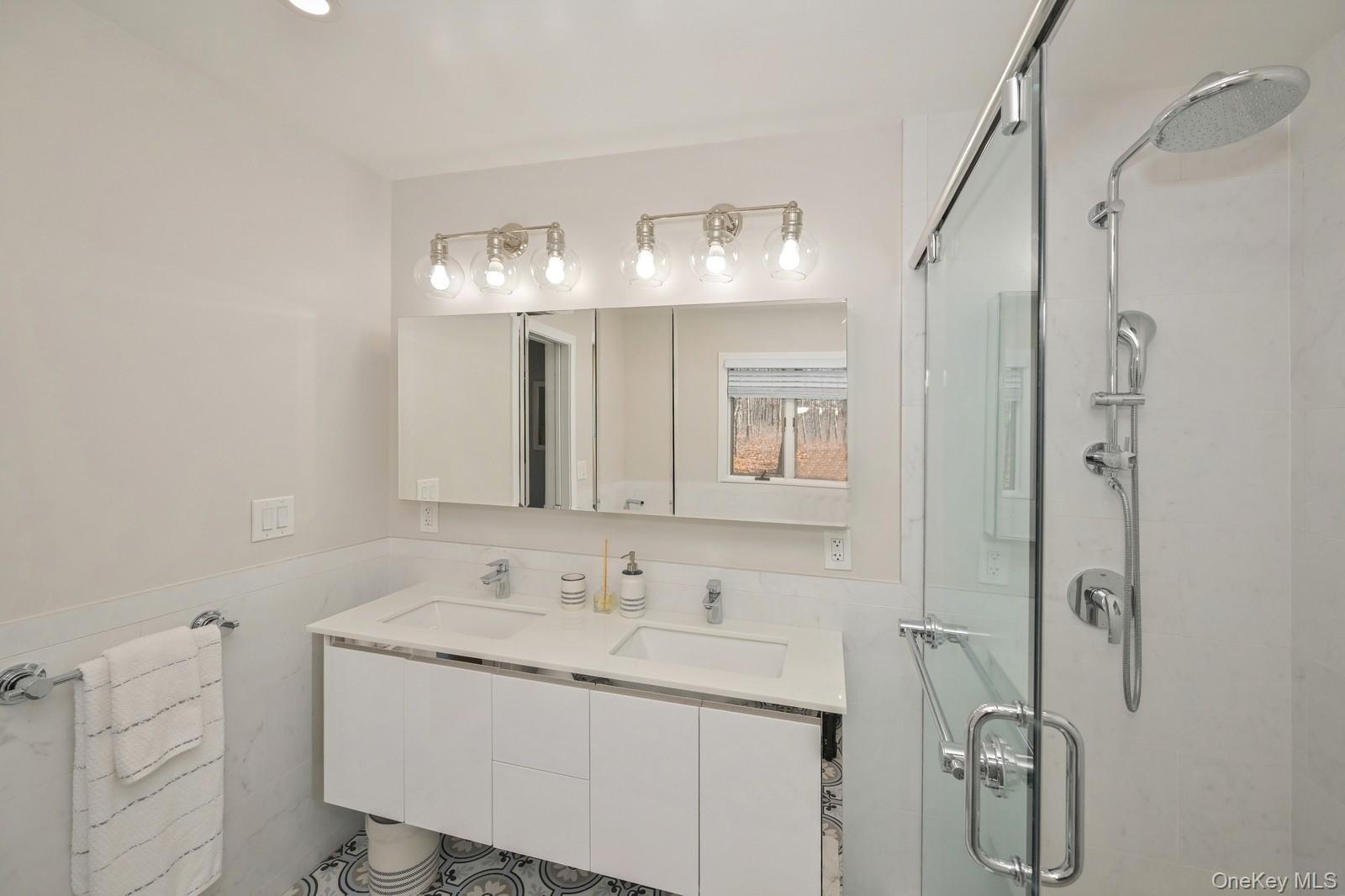 16 Hildreth Road Hampton Bays, NY 11946 - Photo 20 of 29 a bathroom with a sink vanity and shower