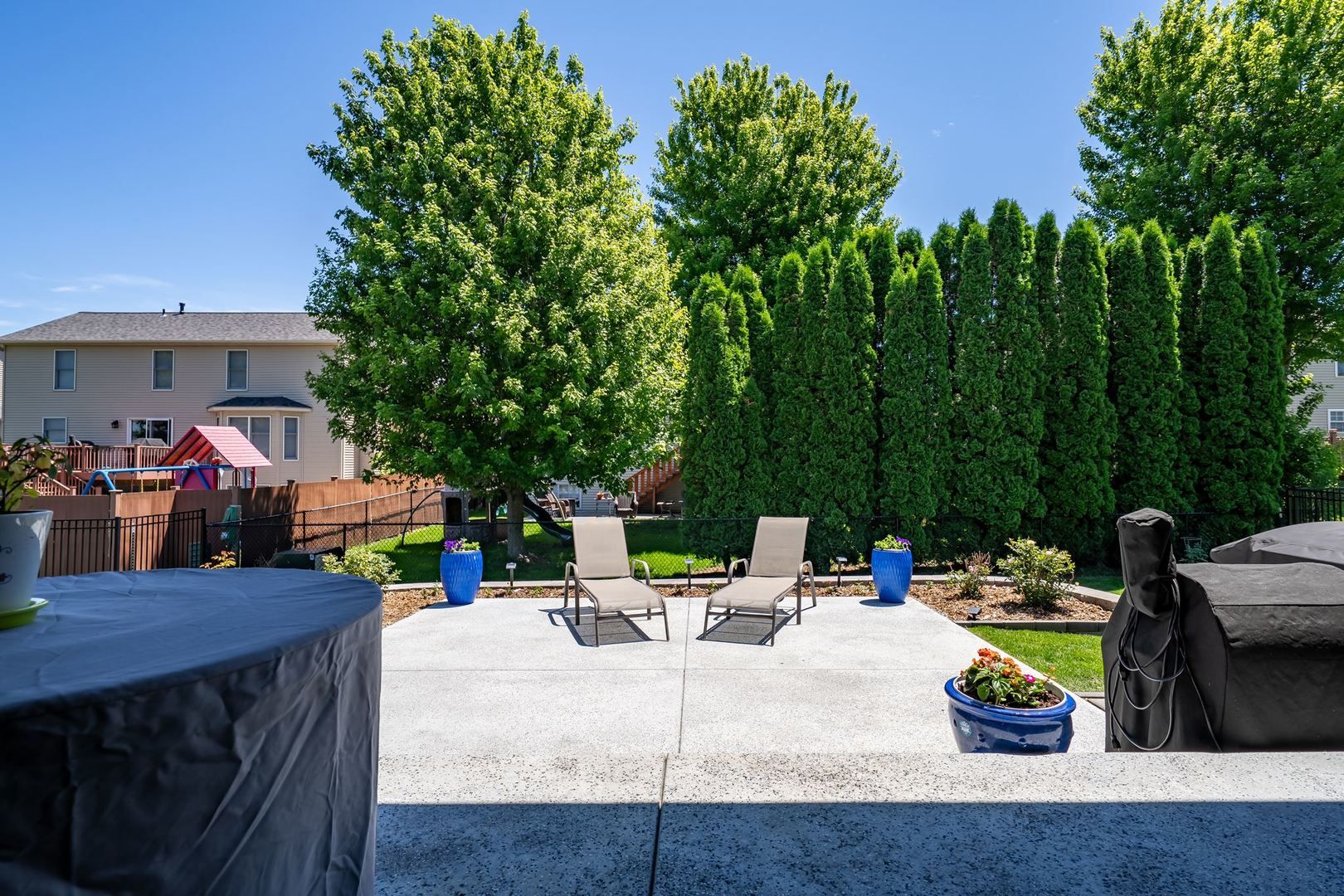 1216 Granite Way Normal, IL 61761 - Photo 28 of 33 a view of a patio with couches and a table and chairs with wooden floor and fence