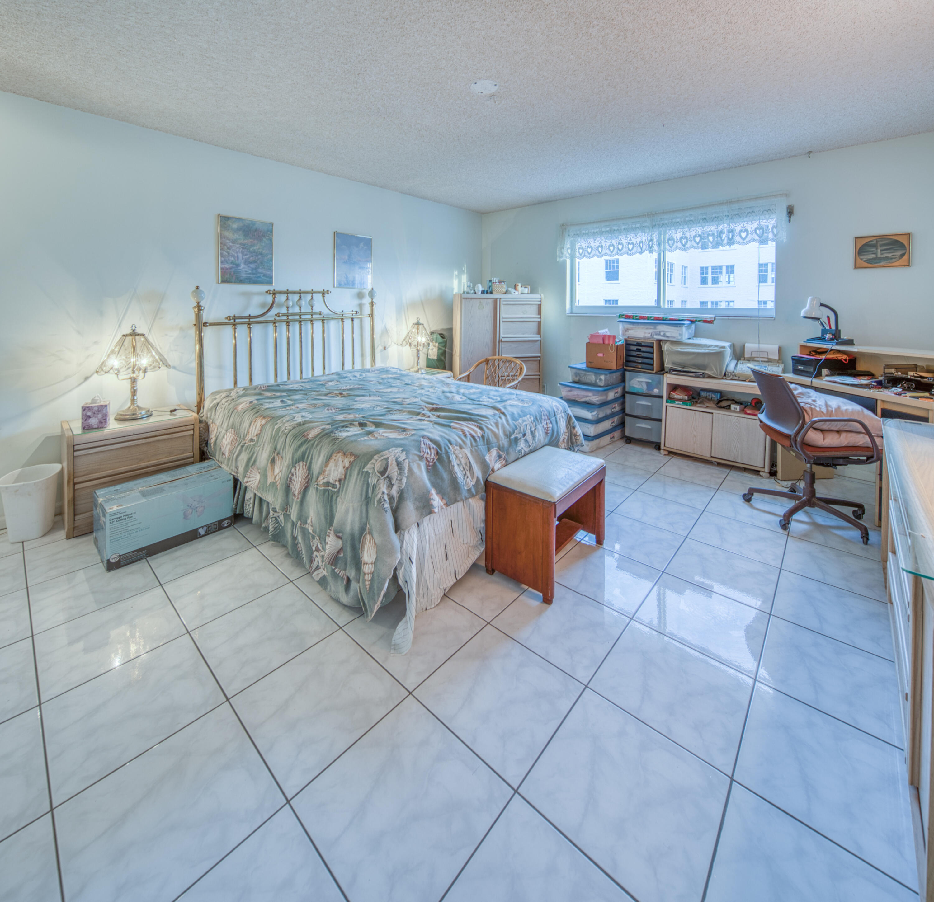 1 North Golfview Road, Unit 601 Lake Worth Beach, FL 33460 - Photo 5 of 51 a spacious bedroom with a bed and a table in it