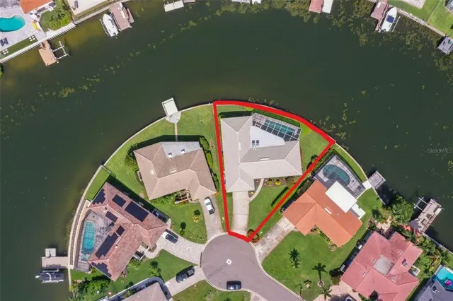 a kitchen with stainless steel appliances granite countertop a stove a refrigerator a dining table and chairs with wooden floor