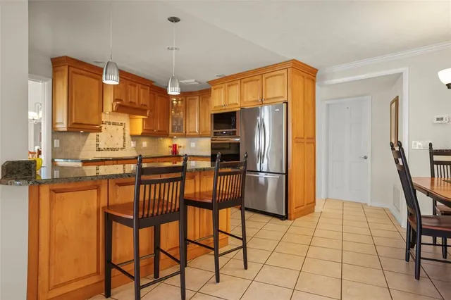 a kitchen with stainless steel appliances granite countertop a sink and dishwasher next to a window
