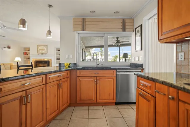 a kitchen with stainless steel appliances granite countertop a refrigerator a sink and a stove