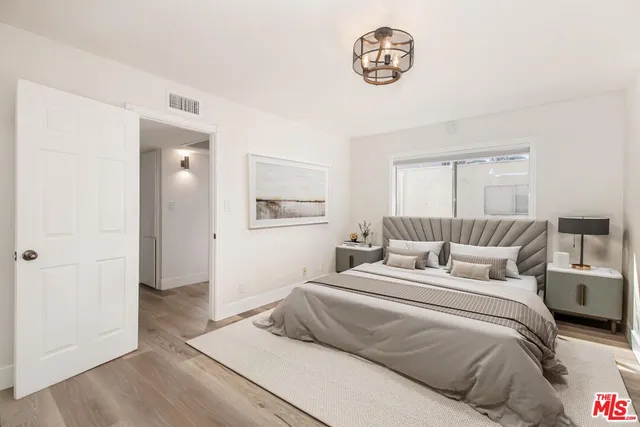 a bedroom with a bed and a table