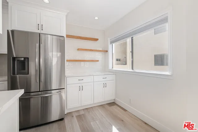 a kitchen with stainless steel appliances a refrigerator sink and cabinets