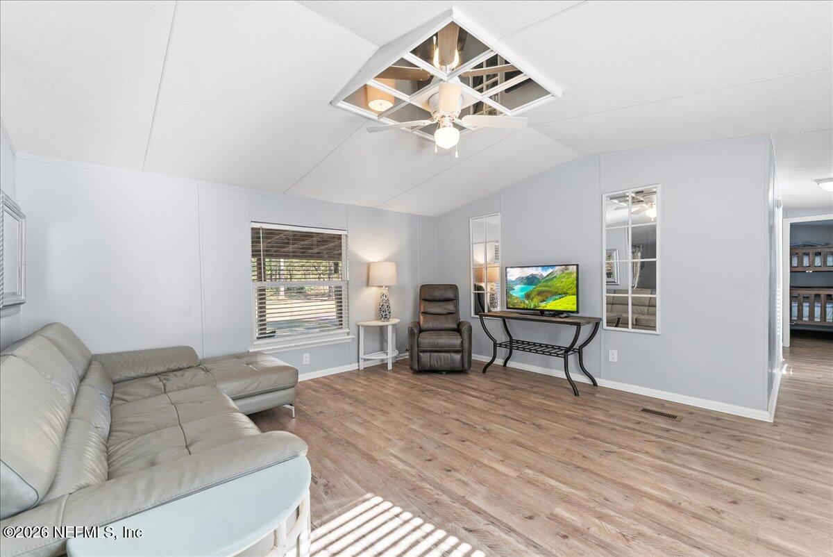 4070 Pinto Road Middleburg, FL 32068 - Photo 16 of 37 a living room with furniture a dining table and a window