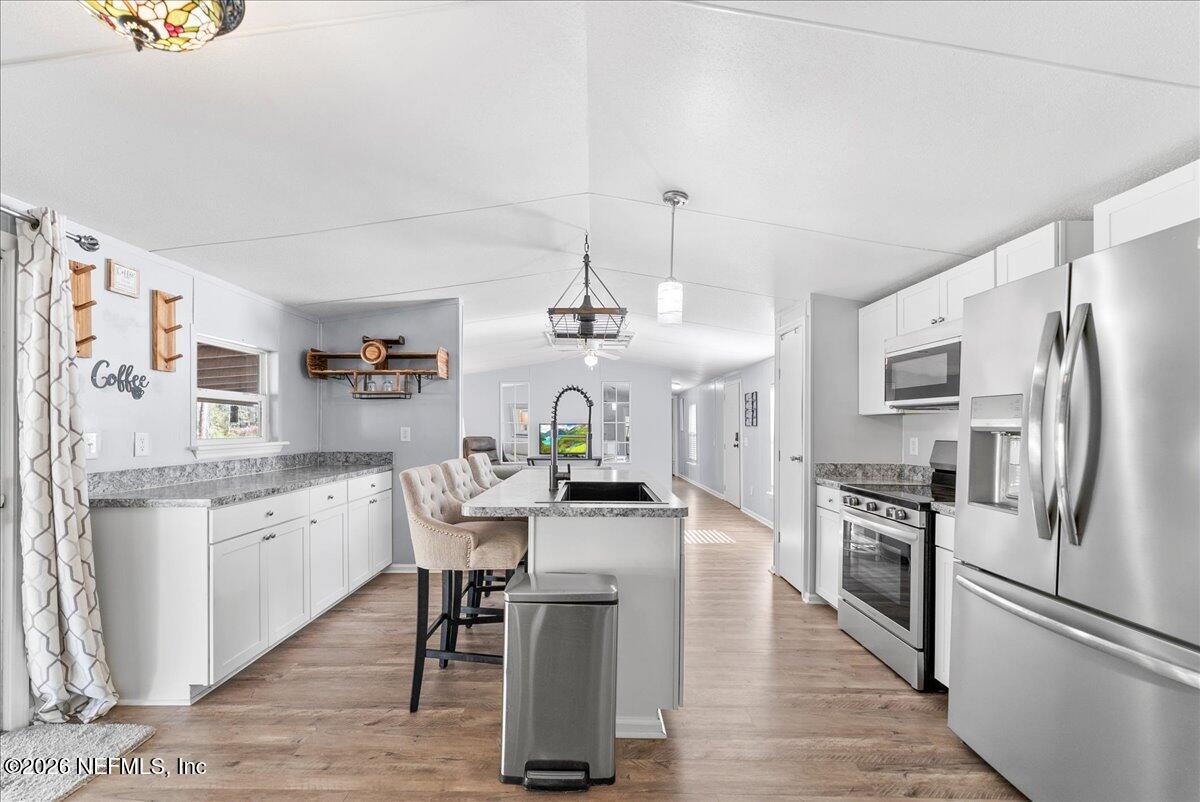 4070 Pinto Road Middleburg, FL 32068 - Photo 19 of 37 a kitchen with stainless steel appliances granite countertop a refrigerator and a stove top oven