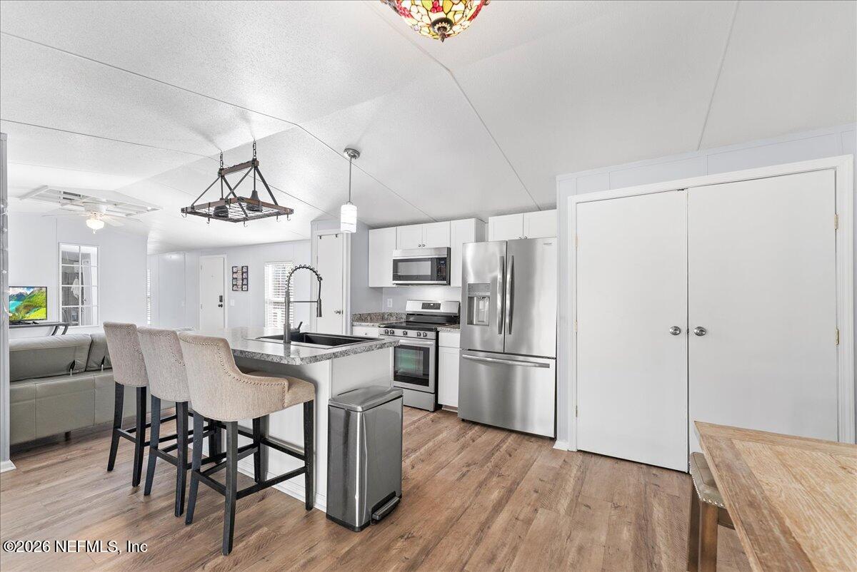 4070 Pinto Road Middleburg, FL 32068 - Photo 20 of 37 a kitchen with cabinets and stainless steel appliances