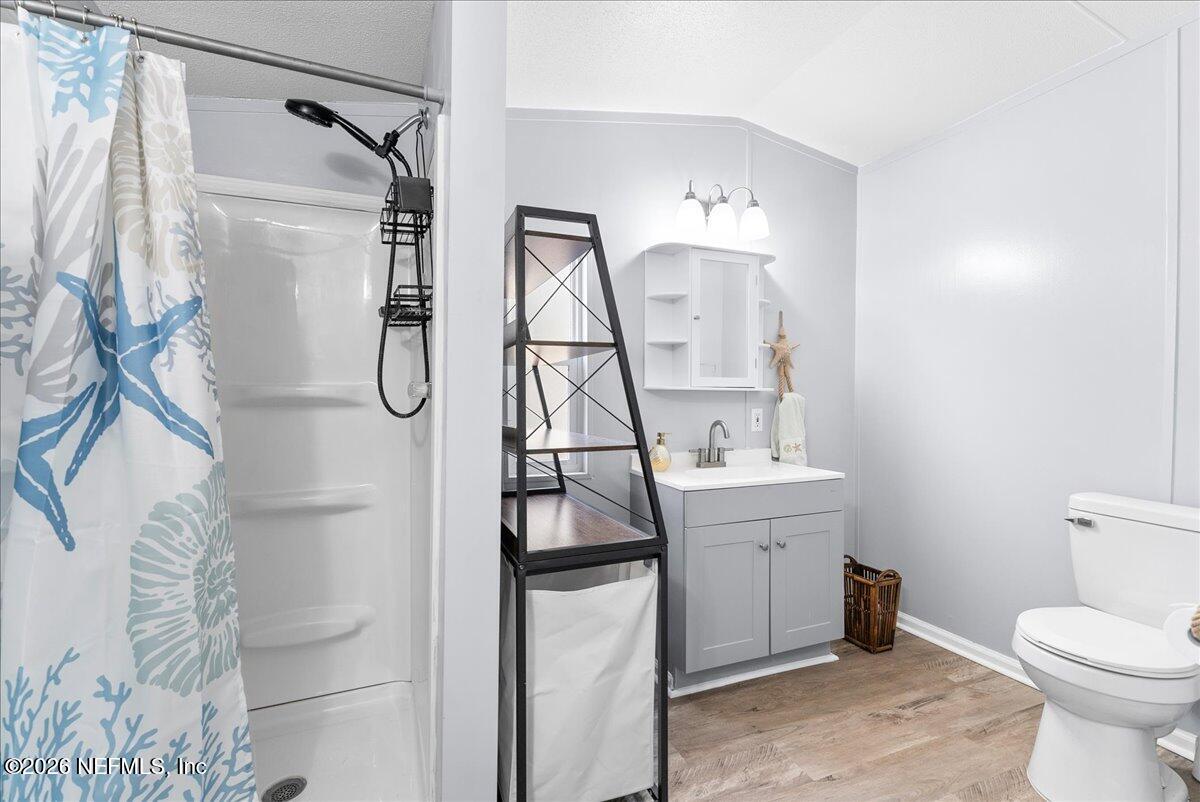 4070 Pinto Road Middleburg, FL 32068 - Photo 27 of 37 a bathroom with a granite countertop sink a toilet and a mirror