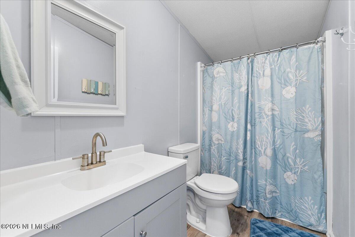 4070 Pinto Road Middleburg, FL 32068 - Photo 29 of 37 a bathroom with a sink a toilet and a mirror