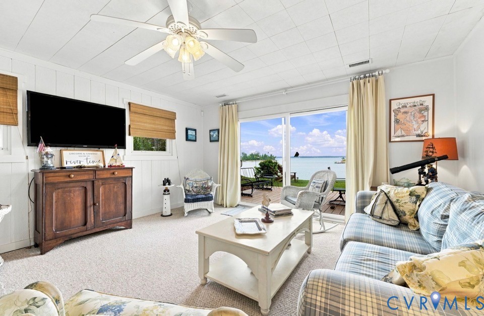 1700 Locust Grove Road Topping, VA 23169 - Photo 26 of 33 Carpeted living area with white paneled walls and