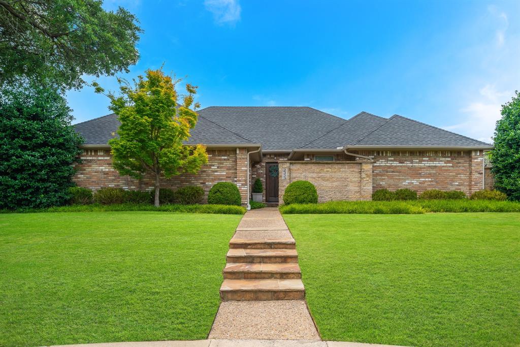 2333 Claridge Circle Plano, TX 75075 - Photo 1 of 1 a front view of a house with a garden and yard