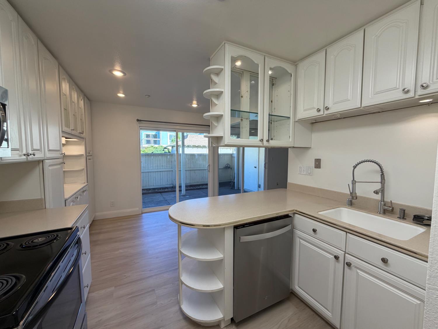 6241 Riverside Boulevard, Unit 112 Sacramento, CA 95831 - Photo 2 of 33 a kitchen with stainless steel appliances granite countertop a sink a stove and wooden floors