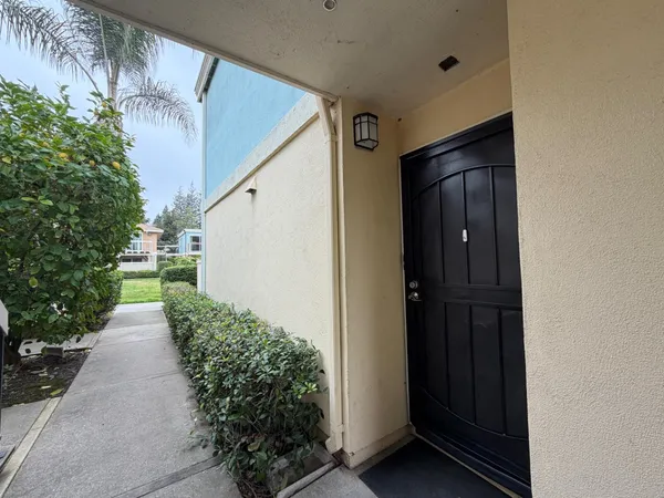 a view of a pathway of a house with a yard