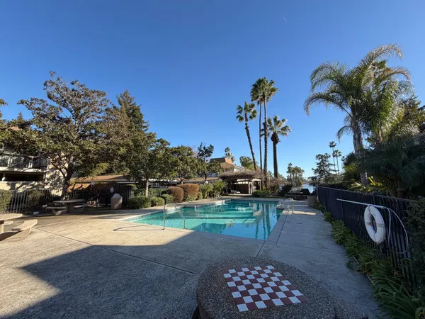 a view of a swimming pool with a table and chairs