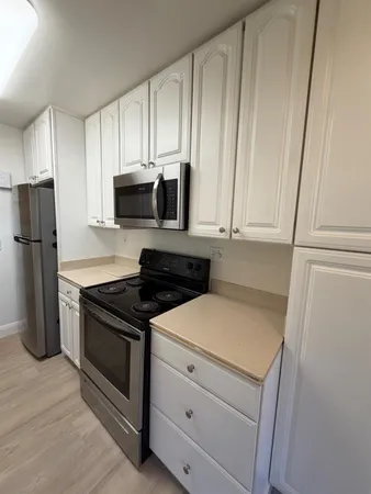 a kitchen with a stove and a refrigerator