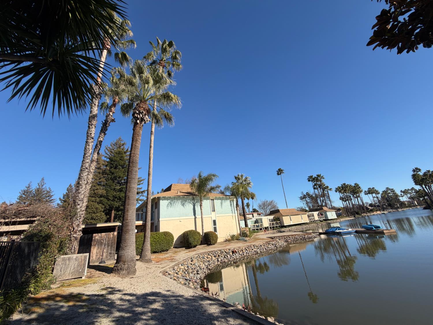 6241 Riverside Boulevard, Unit 112 Sacramento, CA 95831 - Photo 31 of 33 a view of a swimming pool with a table and chairs