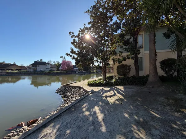 a view of a lake with houses in the background
