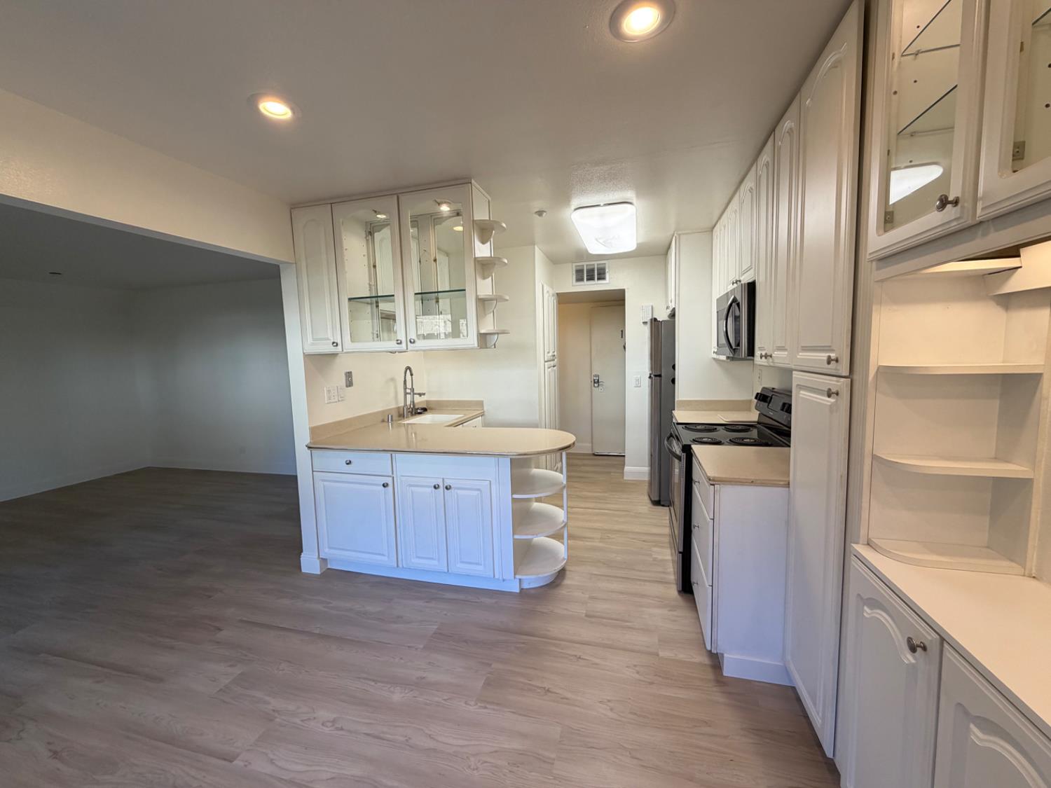 6241 Riverside Boulevard, Unit 112 Sacramento, CA 95831 - Photo 4 of 33 a kitchen with stainless steel appliances kitchen island granite countertop a refrigerator and a sink