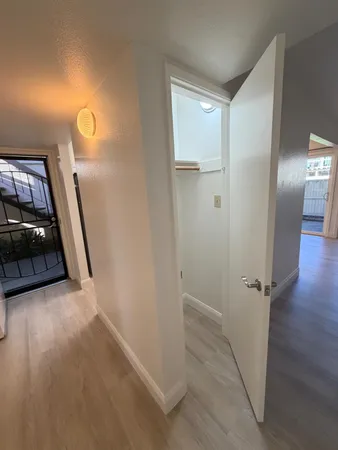 a view of a hallway to a livingroom and a couch