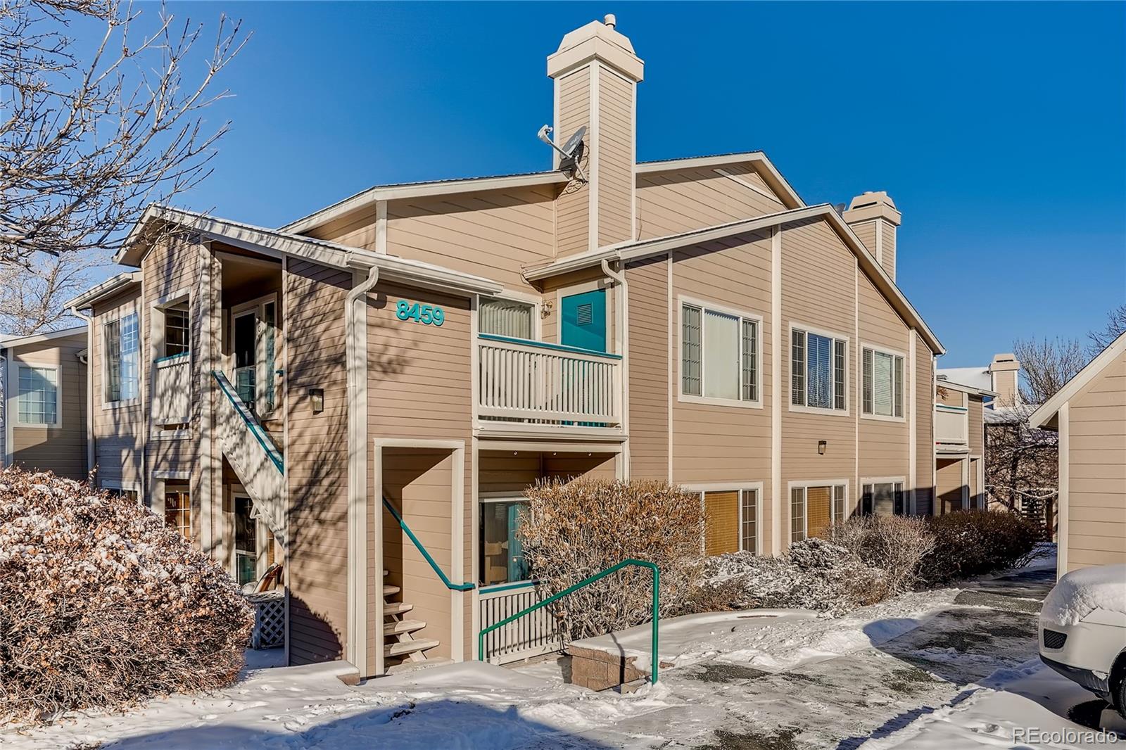 8459 South Little Rock Way, Unit 201 Highlands Ranch, CO 80126 - Photo 1 of 28 a front view of a house with a yard