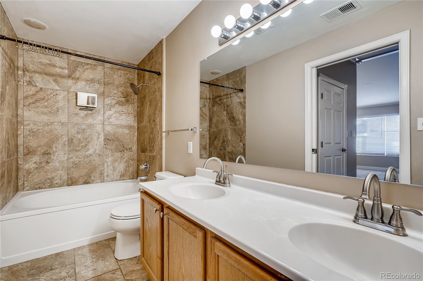8459 South Little Rock Way, Unit 201 Highlands Ranch, CO 80126 - Photo 16 of 28 a bathroom with a sink a toilet and shower