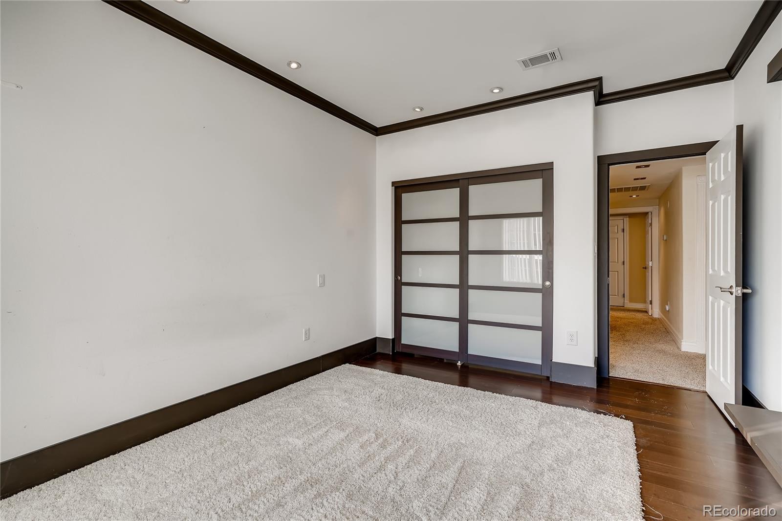 8459 South Little Rock Way, Unit 201 Highlands Ranch, CO 80126 - Photo 20 of 28 a view of a big room with wooden floor and cabinet