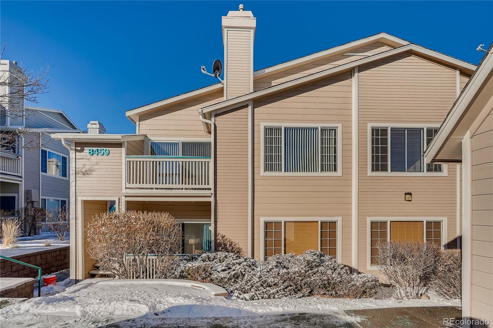 8459 South Little Rock Way, Unit 201 Highlands Ranch, CO 80126 - Photo 2 of 28 a front view of a house with garden