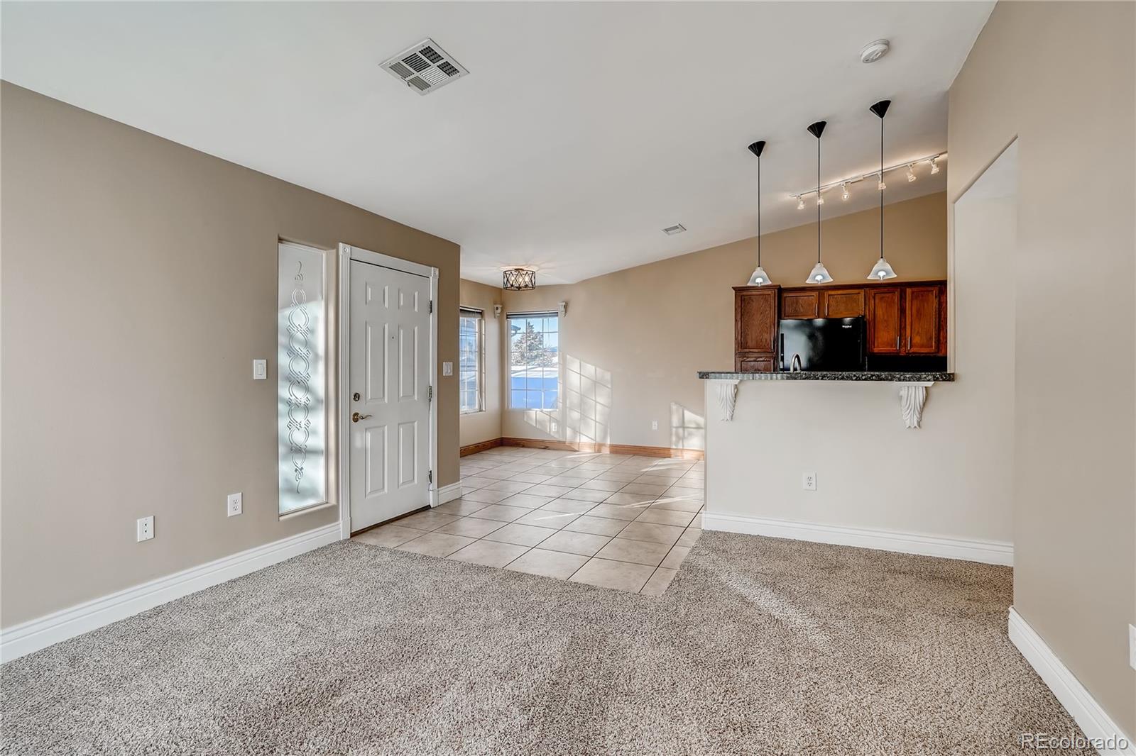 8459 South Little Rock Way, Unit 201 Highlands Ranch, CO 80126 - Photo 6 of 28 a view of a kitchen with a sink and a cabinet in an empty room