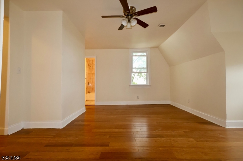 34 Hedden Terrace, Unit 3 Newark, NJ 07108 - Photo 4 of 13 a view of an empty room with wooden floor and a window