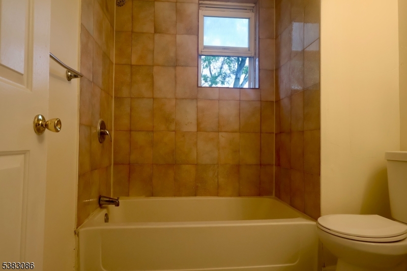 34 Hedden Terrace, Unit 3 Newark, NJ 07108 - Photo 6 of 13 a bathroom with a toilet and shower