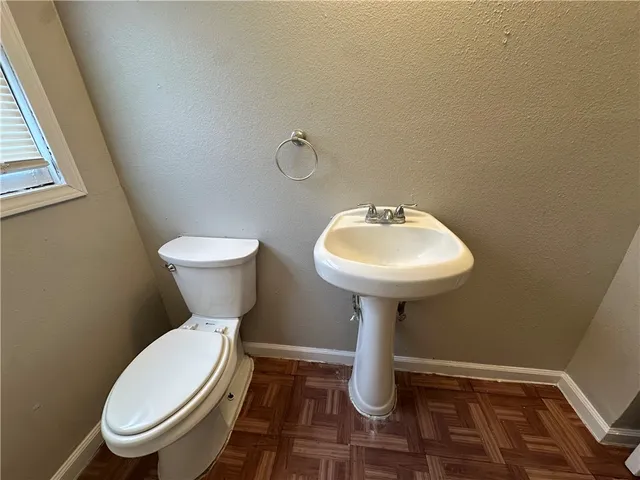 an empty room with a chandelier fan and a fan