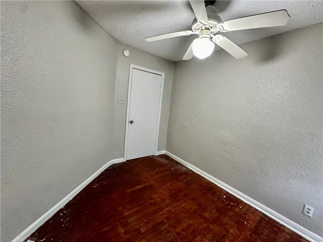 an empty room with wooden floor and closet