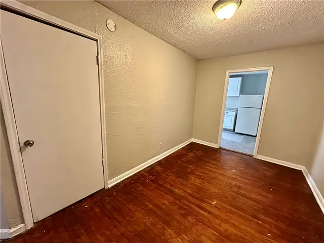 an empty room with wooden floor