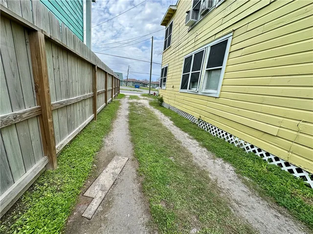 a front view of a house with a yard glass top table and chairs