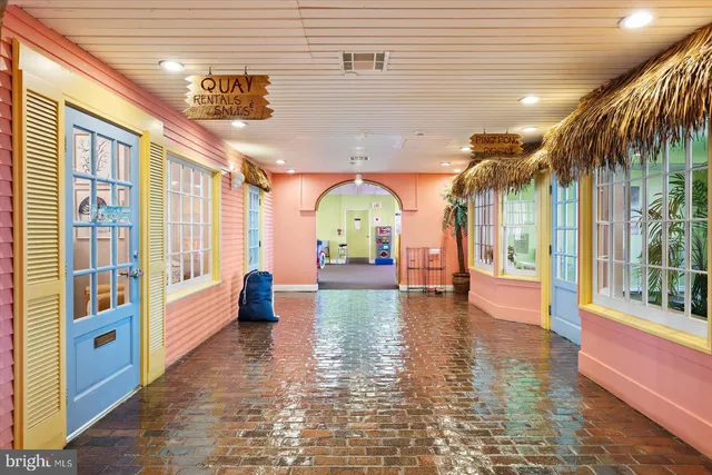a view of a dining room with furniture and a potted plant