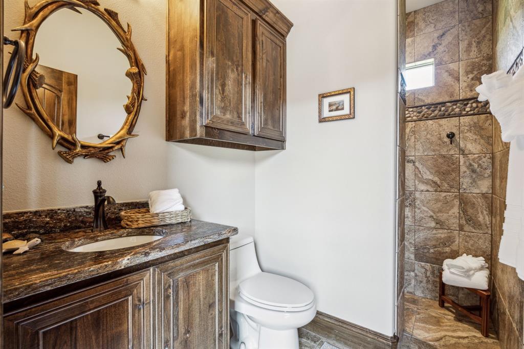10761 County Road 2326 Terrell, TX 75160 - Photo 22 of 35 Bathroom with toilet, vanity, and tiled shower