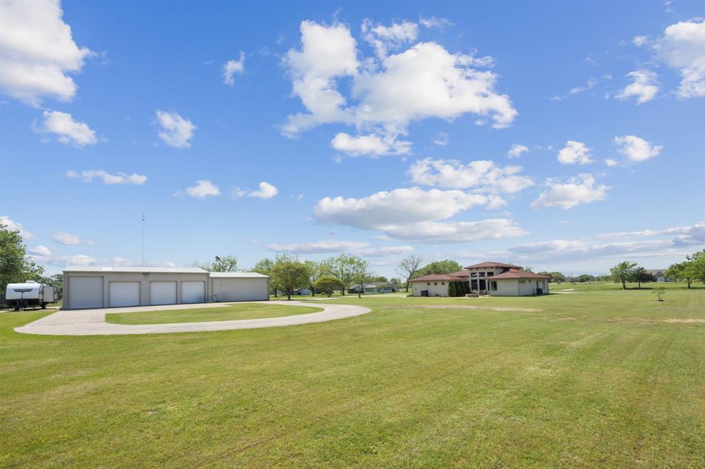10761 County Road 2326 Terrell, TX 75160 - Photo 24 of 35 View of yard with a garage, driveway, and an shop