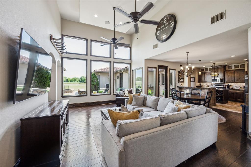 10761 County Road 2326 Terrell, TX 75160 - Photo 6 of 35 Living room with ceiling fan with notable chandelier, a towering ceiling, dark wood-style floors, and visible vents