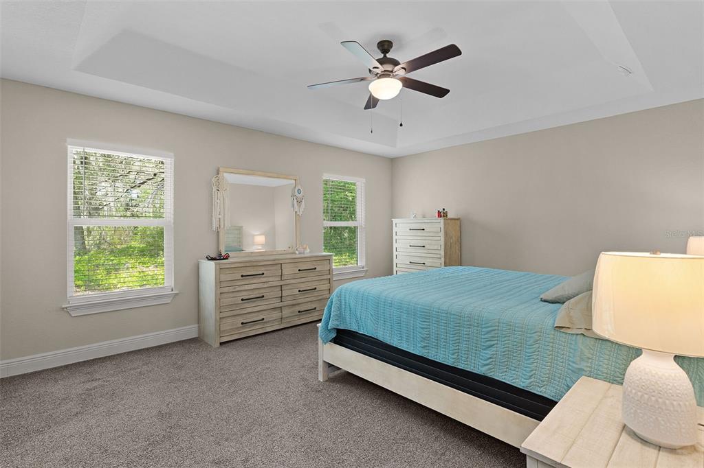 13 Malauka Radial Run Road Ocklawaha, FL 32179 - Photo 11 of 32 a bedroom with a bed and a window