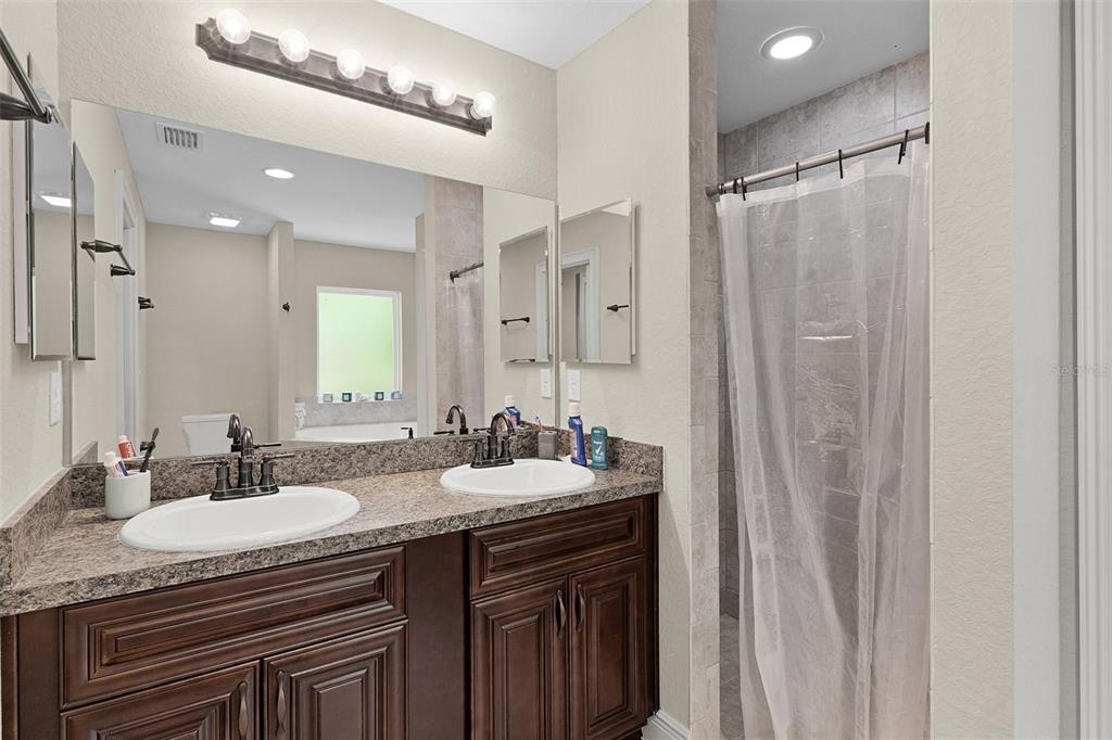 13 Malauka Radial Run Road Ocklawaha, FL 32179 - Photo 20 of 32 a bathroom with double sink and a mirror