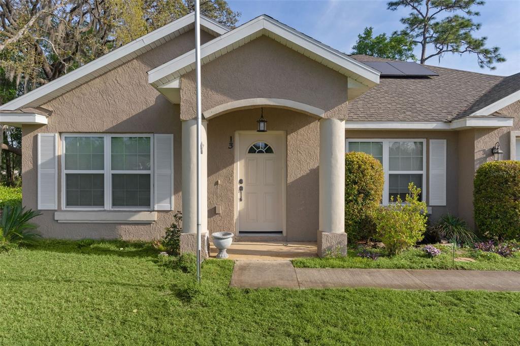 13 Malauka Radial Run Road Ocklawaha, FL 32179 - Photo 2 of 32 a front view of a house with garden