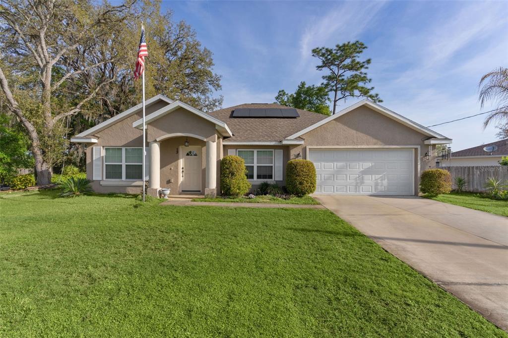 13 Malauka Radial Run Road Ocklawaha, FL 32179 - Photo 25 of 32 a front view of a house with a garden