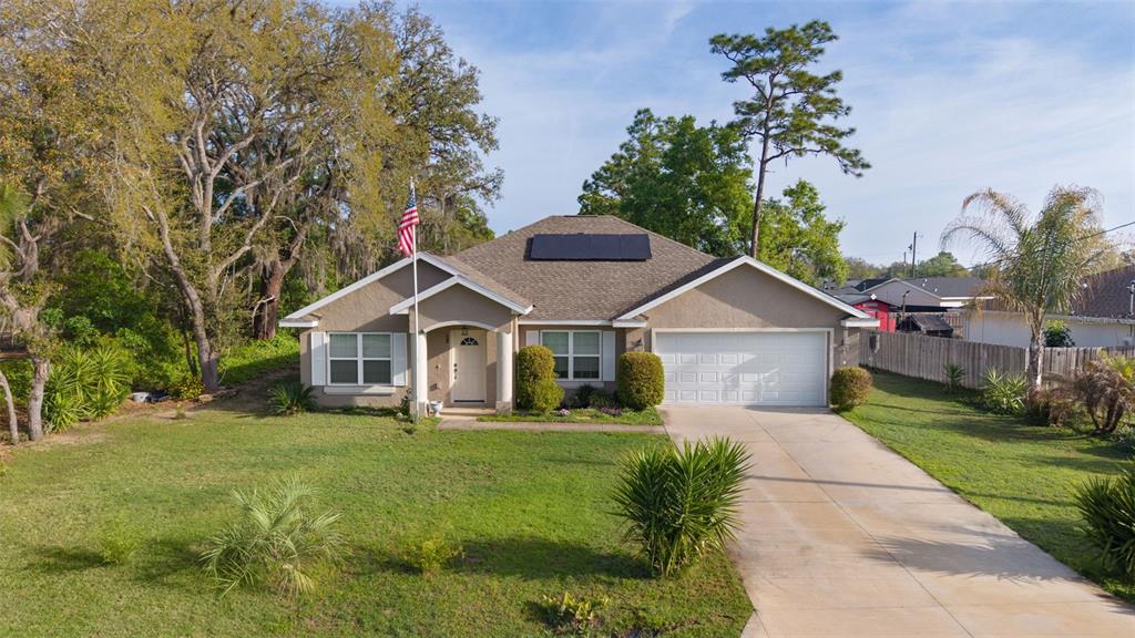 13 Malauka Radial Run Road Ocklawaha, FL 32179 - Photo 6 of 32 a front view of a house with garden
