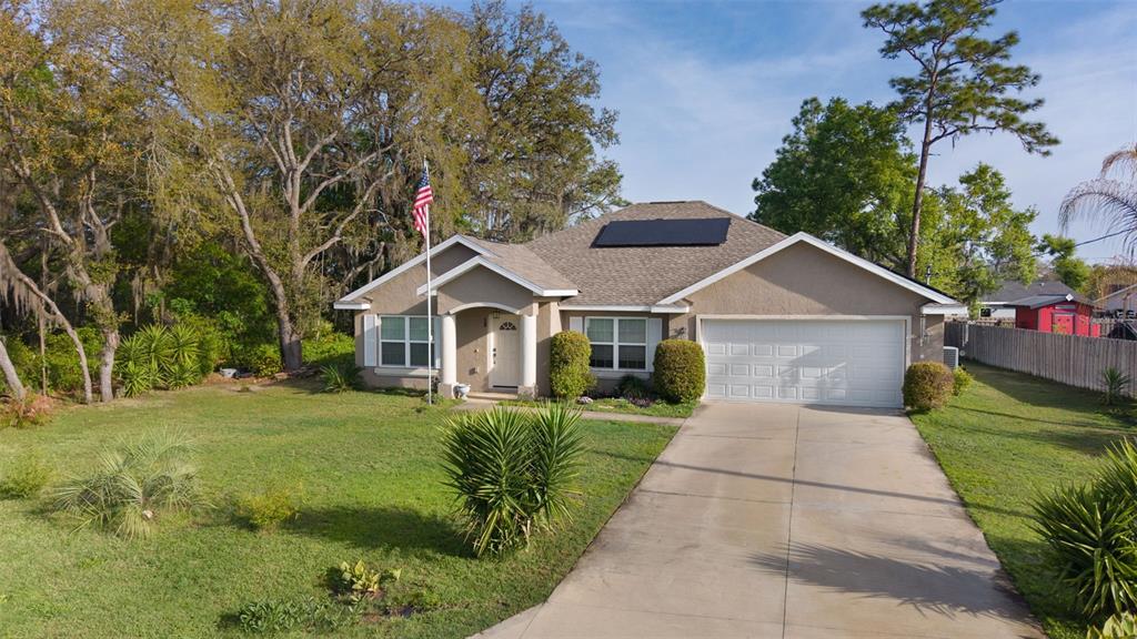 13 Malauka Radial Run Road Ocklawaha, FL 32179 - Photo 7 of 32 a front view of a house with garden